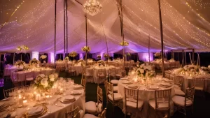 Professional event lighting illuminating an elegant white wedding tent at sunset | Event lighting for tented events